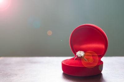 Close-up of red ring box on table