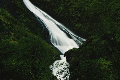 Scenic view of waterfall against sky