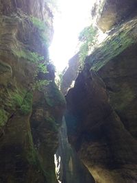 Low angle view of waterfall amidst rocks