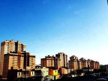 Low angle view of buildings against blue sky