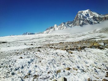 Snowcapped mountains against clear blue sky