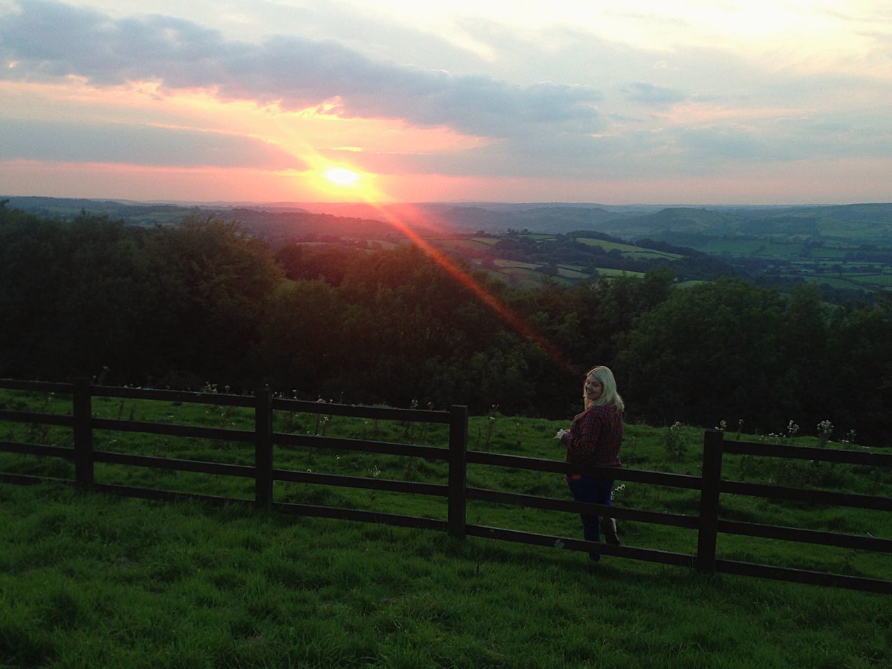 leisure activity, landscape, sky, lifestyles, sunset, field, grass, tranquil scene, scenics, tranquility, beauty in nature, nature, sun, cloud - sky, sunlight, rural scene, mountain, casual clothing, idyllic, outdoors, grassy, green color, cloud, orange color, non-urban scene