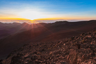 Scenic view of mountains against sky during sunset