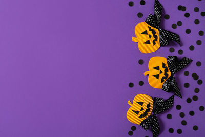 Close-up of yellow butterfly over purple background