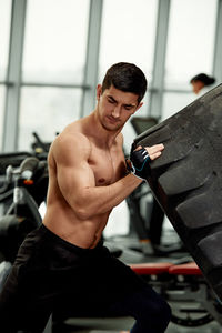 Side view of man exercising in gym