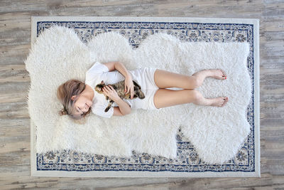 High angle view of woman lying on rug