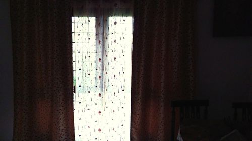 Close-up of curtain against window at home