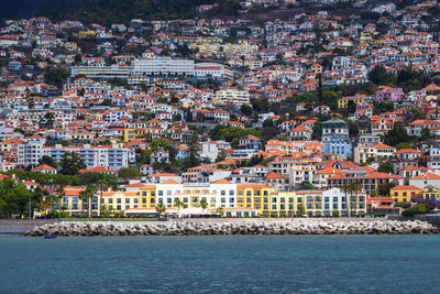 High angle view of townscape by sea