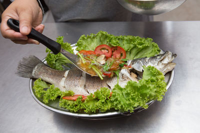 Midsection of person preparing food