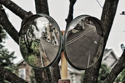 Low angle view of street mirrors