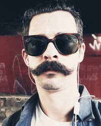 Close-up portrait of young man wearing sunglasses