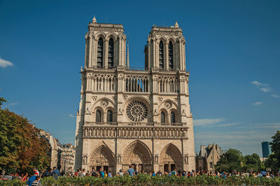 People and the gothic facade of notre-dame cathedral in paris. the famous capital of france.