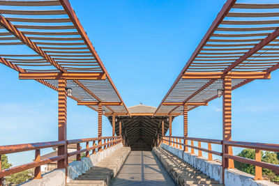 Footbridge against clear blue sky