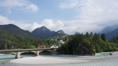 Arch bridge over river against sky