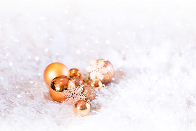 Close-up of christmas ornaments on fur