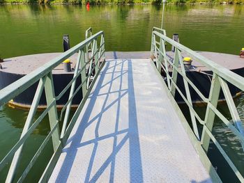High angle view of empty railing by lake
