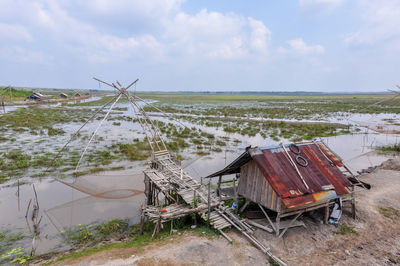 Abandoned ship on field against sky