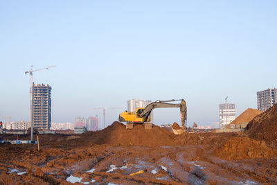 Excavator working at construction site. backhoe digs ground for the foundation 