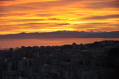 Silhouette buildings against sky during sunset