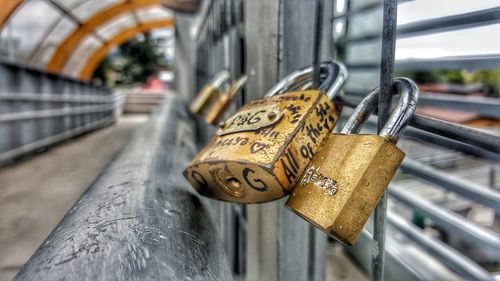 Close-up of padlocks on railing