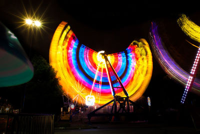 Low angle view of illuminated ferris wheel at night