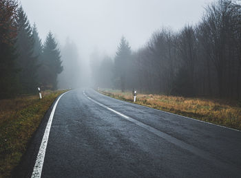 Road amidst trees against sky