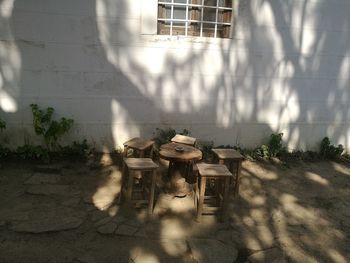 High angle view of tables and chairs against wall