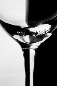 Close-up of beer glass against black background