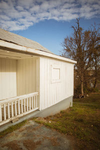 Built structure on field by building against sky