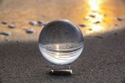 High angle view of glass of water on beach