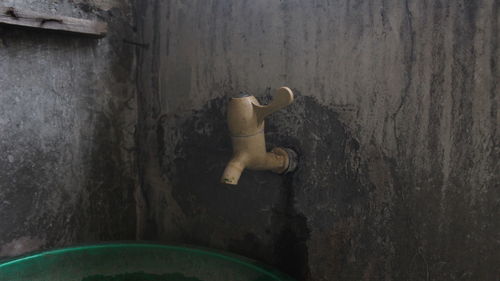 High angle view of toy figurine on wood against wall