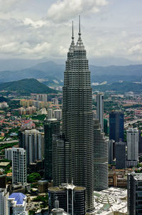 Cityscape against cloudy sky