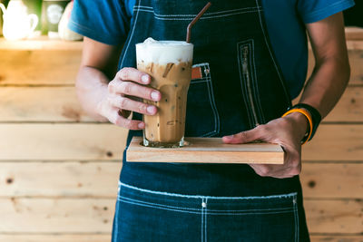 Midsection of man holding drink