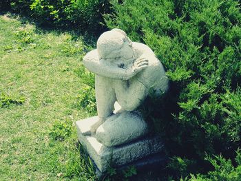 Statue against plants