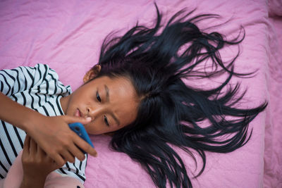 Portrait of a girl lying down on bed