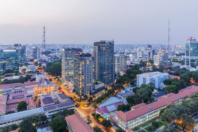 High angle view of city lit up at sunset