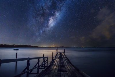 Boat ramp over sea against star field