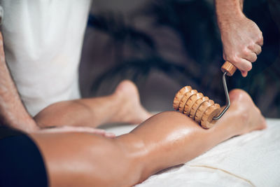 Midsection of man giving massage to woman