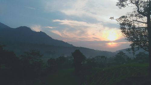 Scenic view of silhouette mountains against sky at sunset