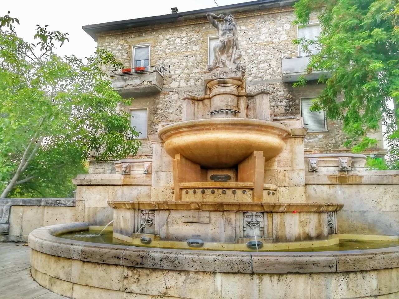 CLOSE-UP OF FOUNTAIN AGAINST BUILDING