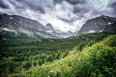 Scenic view of mountains against cloudy sky