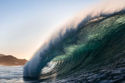 Wave breaking on a sunset beach in canary islands