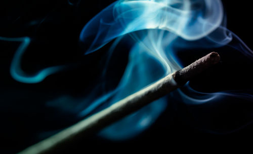 Close-up of burning incense stick 