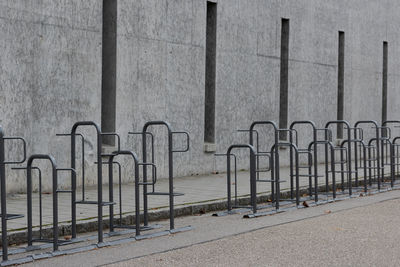 Empty footpath by railing against sea