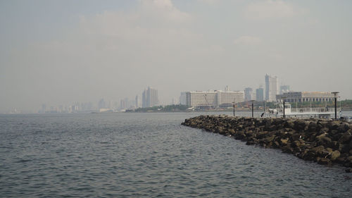 Panorama manila city, skyscrapers and buildings. seascape coastal city of manila. modern city by sea