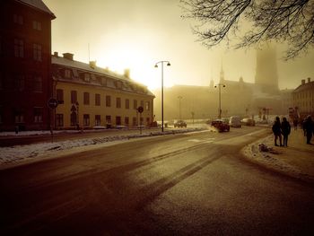 View of city street at sunset