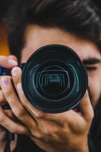 Close-up of man photographing from camera