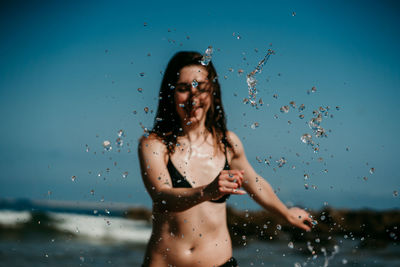 Young woman standing in water