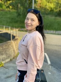 Portrait of smiling young woman standing outdoors