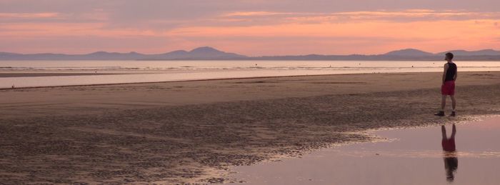 Scenic view of beach against sky during sunset